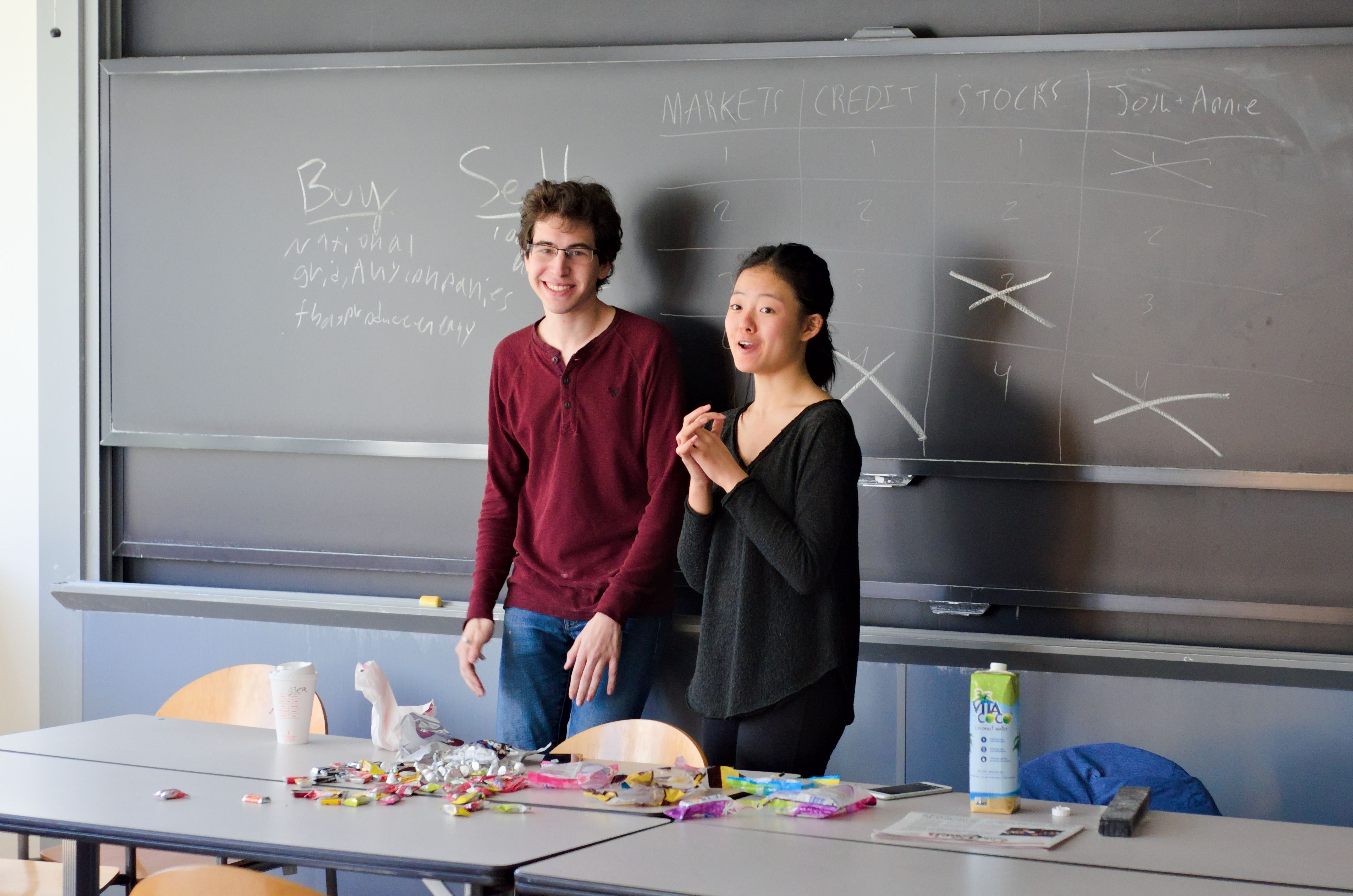 Two teachers standing in front of a chalkboard